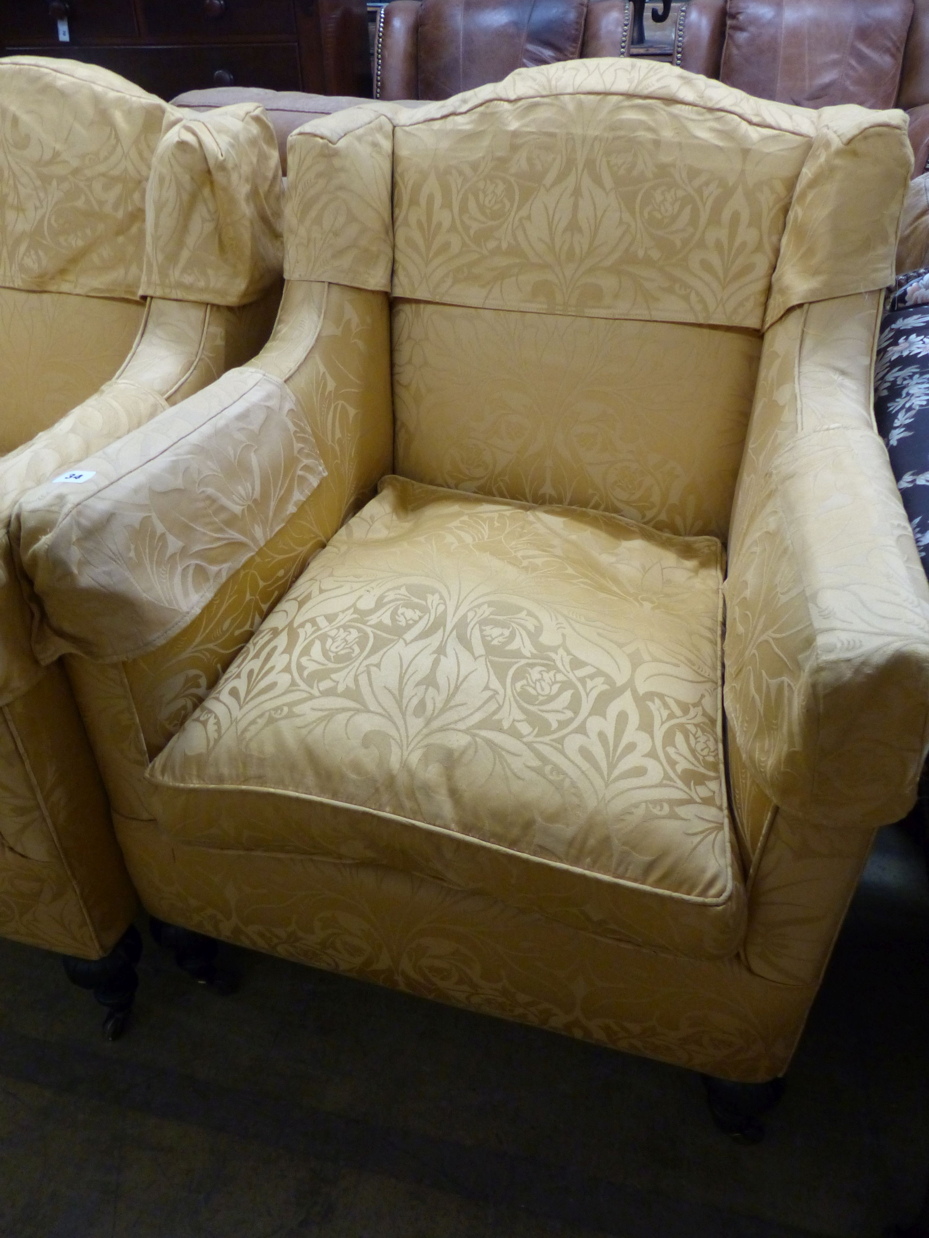 A pair of Victorian square framed armchairs, upholstered in gold damask, on carved legs and castors, W.70cm D.70m H.92cm